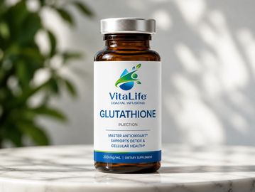 A bottle of VitaLife Glutathione dietary supplement on a white surface.