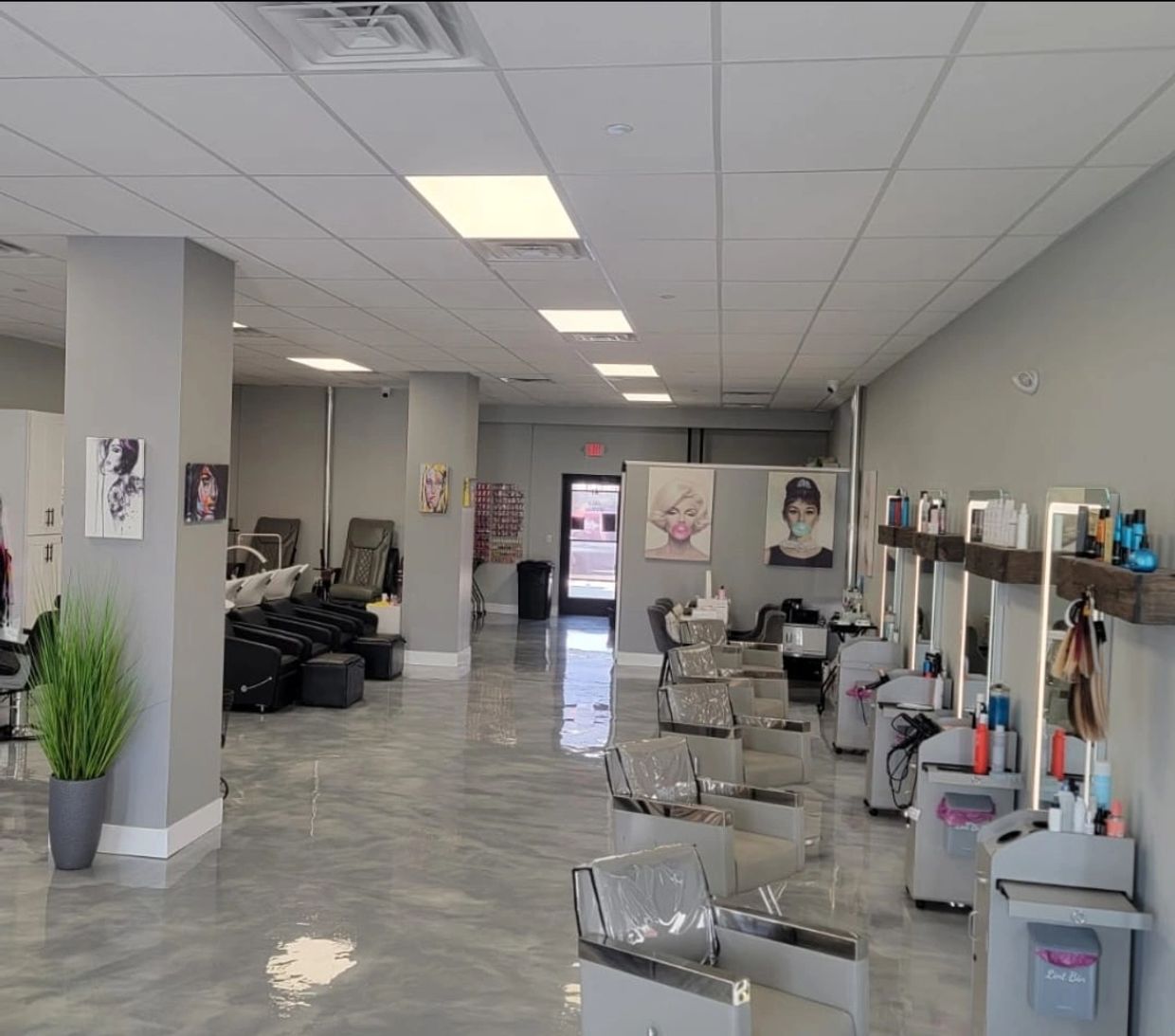 Modern hair salon with sleek styling stations and wash areas.
