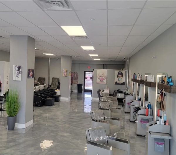 Modern hair salon with sleek styling stations and wash areas.