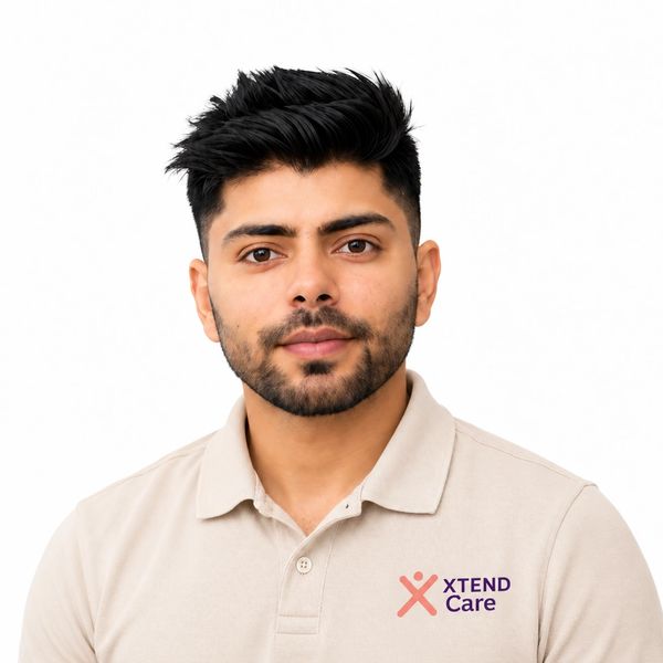 Young man in a beige Xtend Care polo shirt.