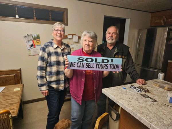 Co-owner Diane Bickford with happy sellers