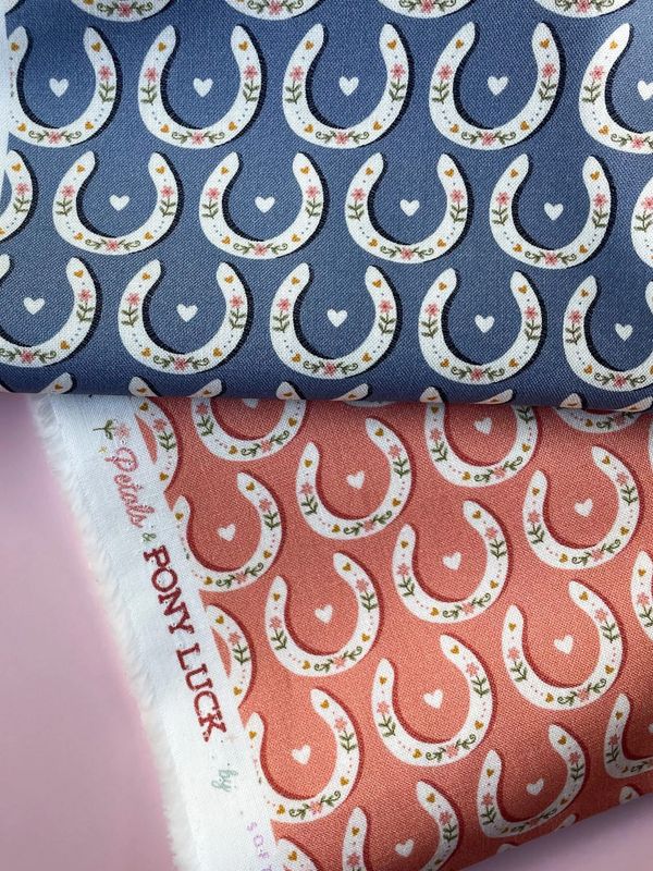 Horseshoe patterned fabrics in peach and blue from Pony Luck collection.