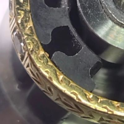 Close-up of a watch's internal mechanism and decorative gold edge.