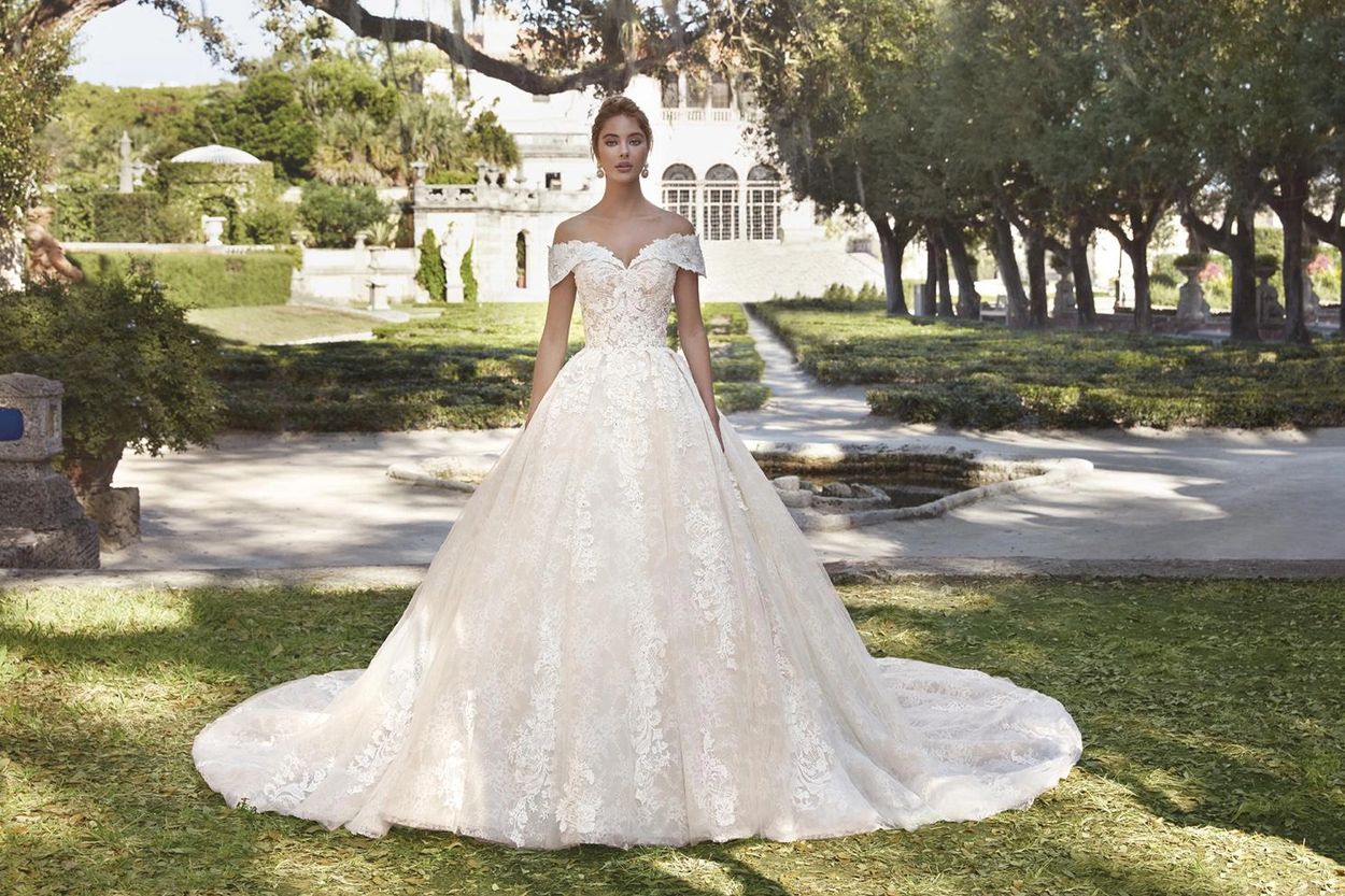 Off-the-shoulder bodice with portrait collar. Chantilly lace, beading, semi-Cathedral train.