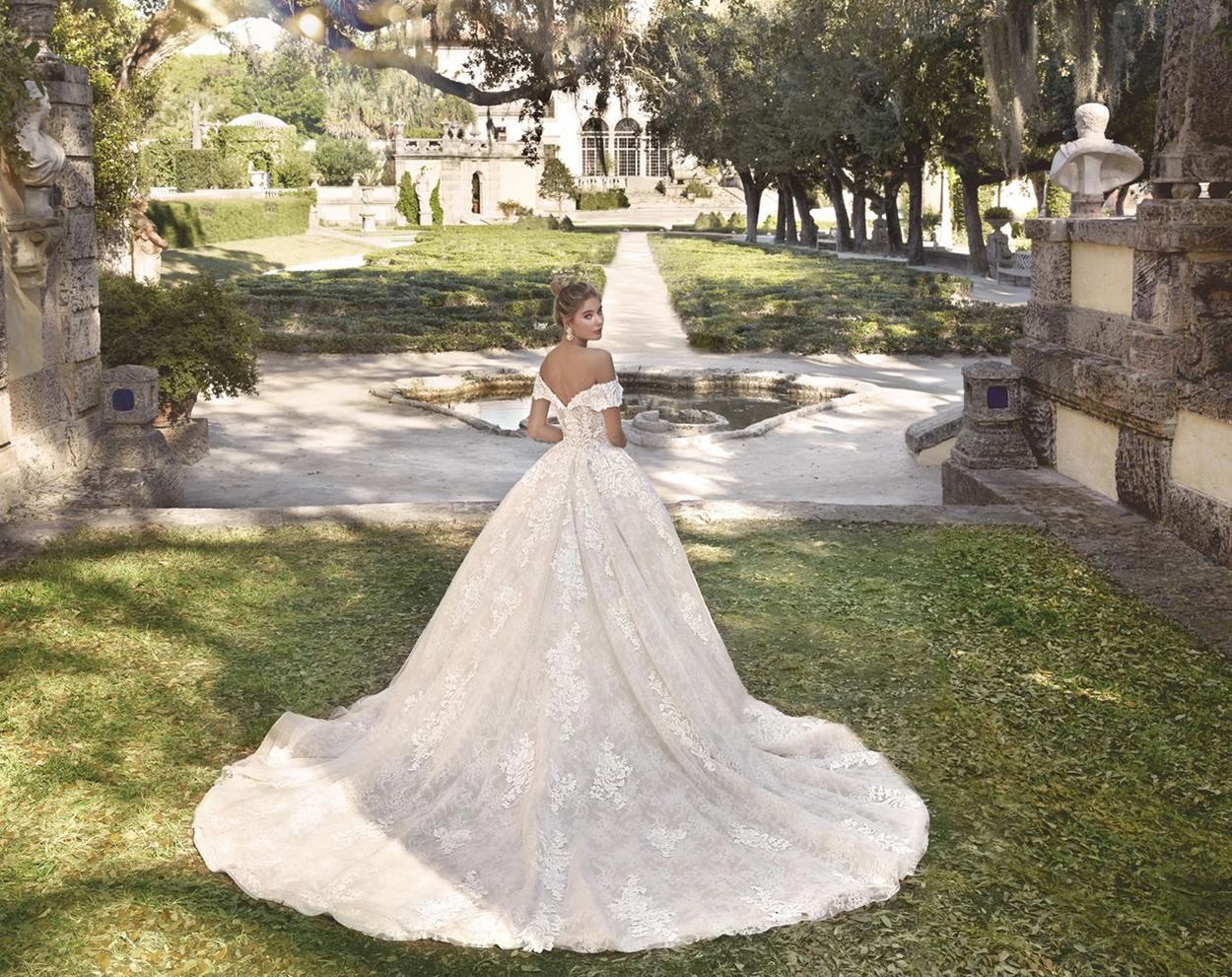 Off-the-shoulder bodice with portrait collar. Chantilly lace, beading, semi-Cathedral train.