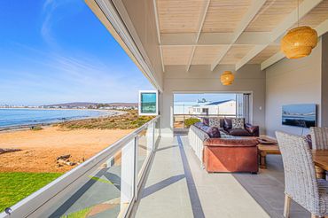 Spacious beachside living room with ocean view and natural light.