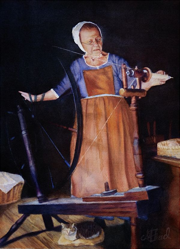 A woman spins wool at a walking wheel while a cat sleeps peacefully beneath on a an aged wood floor.