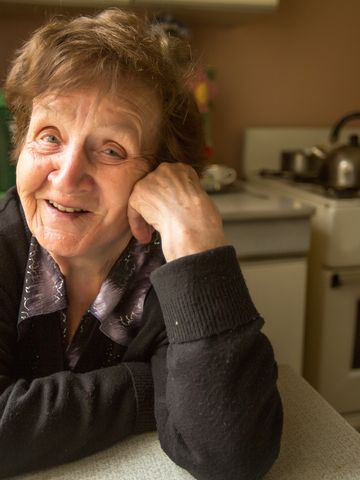 Older lady smiling in her kitchen