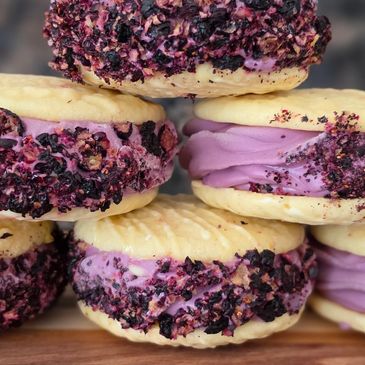 Cookies with purple cream and berry pieces.
