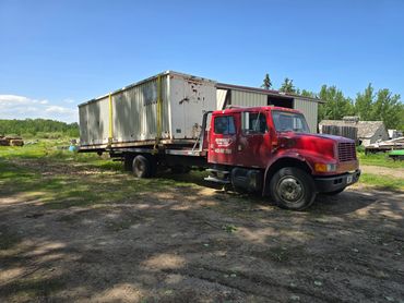 Unit 2 hauling a 30' storage shed for a customer.