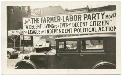 A Farmer-Labor political poster atop an automobile.