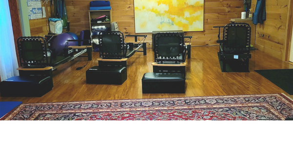 photo of yoga and wellness studio showing 4 pilates reformer machines