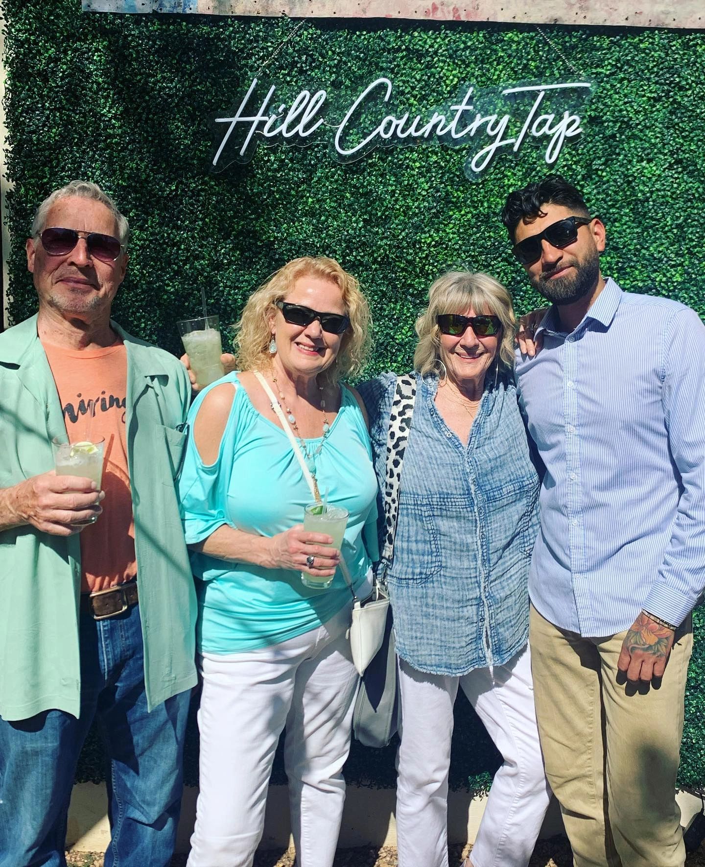 Group of people smiling with drinks in hand