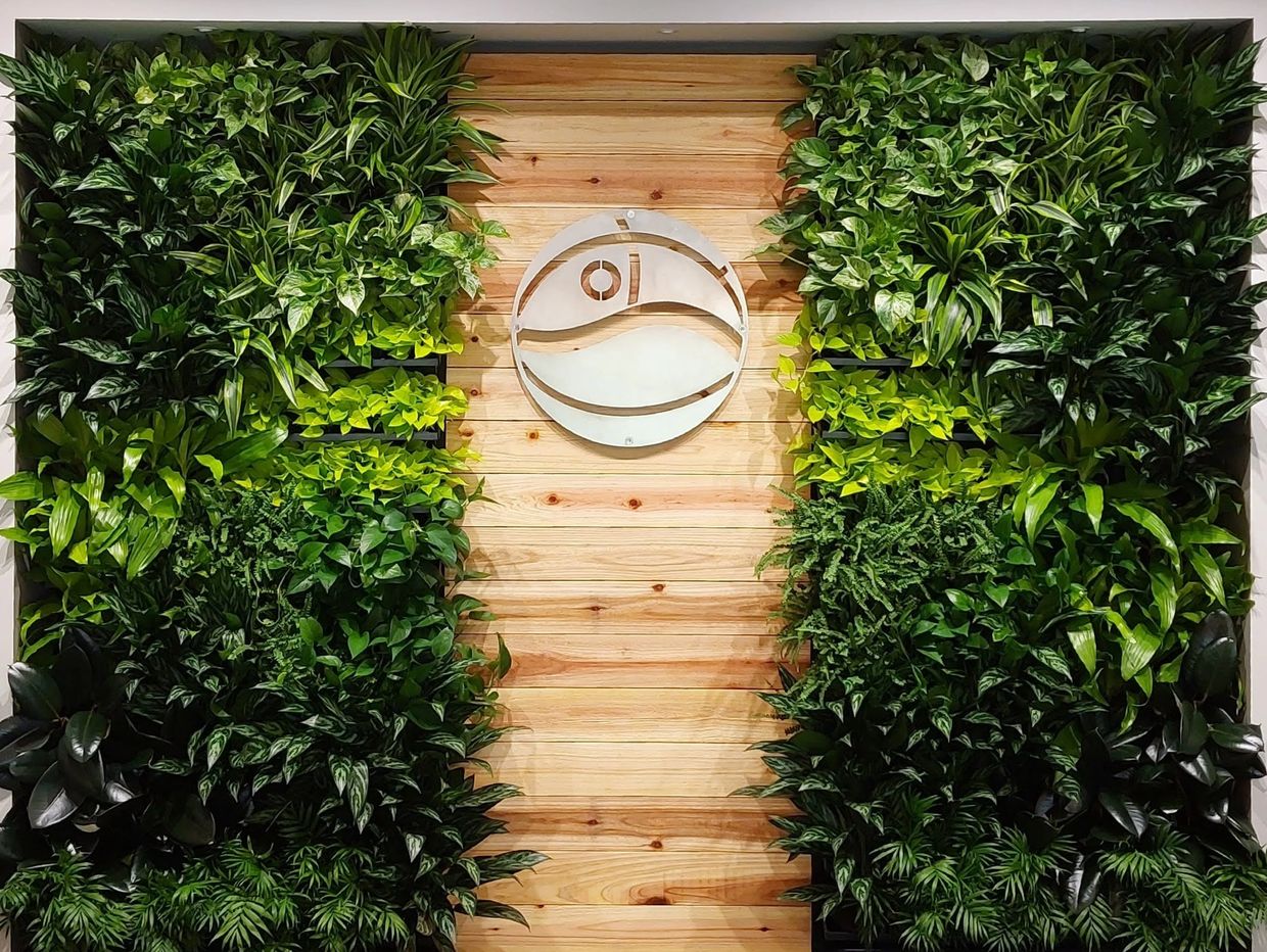 Eight foot high Living Wall with custom wood and metal company logo. Contains 120 plants.