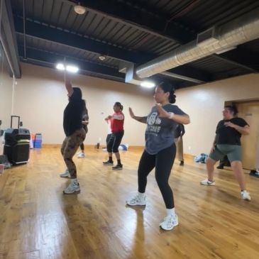 Group dance class in progress in a studio.