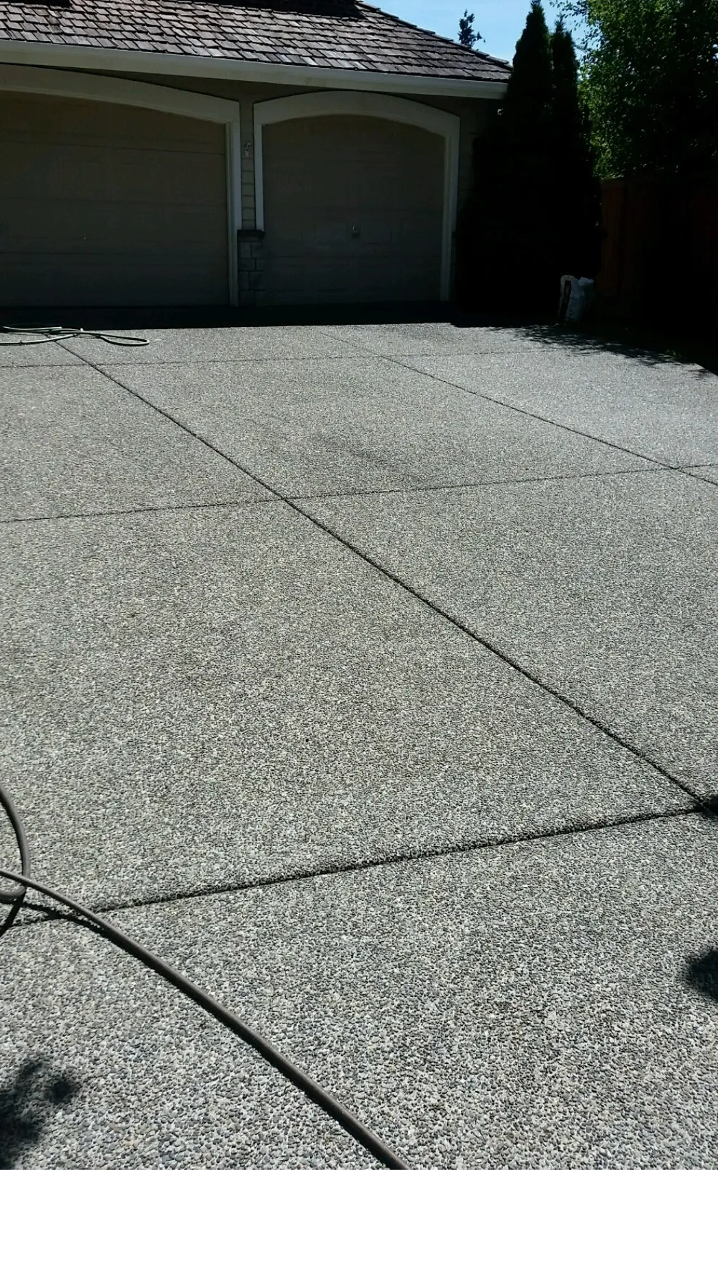 A freshly pressure washed driveway in Woodinville after we cleaned the gutters on a residential home