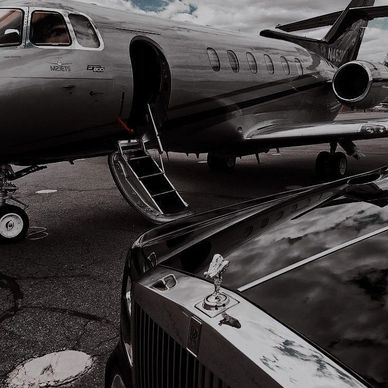 Private jet and a luxury car. 