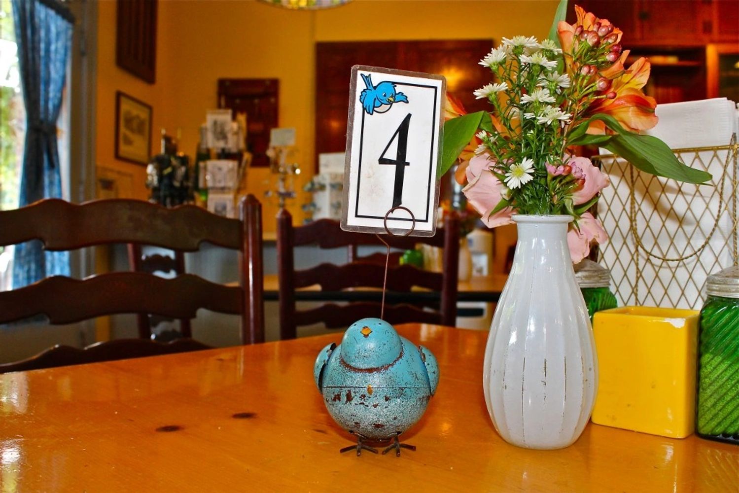 Table with bluebird table marker sitting inside Bluebird Bakery and Cafe.