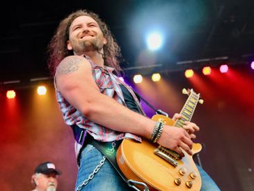 Kevin Wierzgac, guitar player in Lynyrd Skynyrd tribute band Freebyrd looking out at crowd