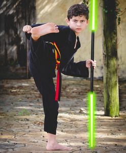 Young martial artist with a glowing green staff.