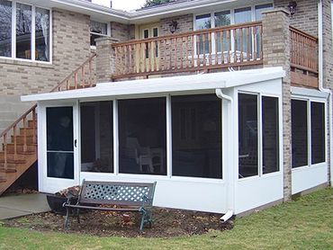Sunroom under existing deck with studio extension