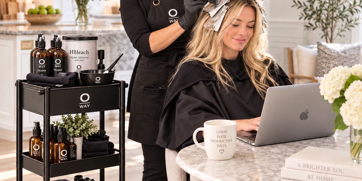 Woman getting hair highlighted while working on laptop.