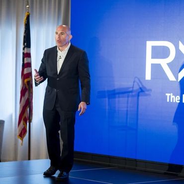 Keynote speaker on stage during a corporate seminar in Nashville