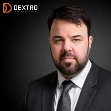 Professional man in a suit with Dextro logo.