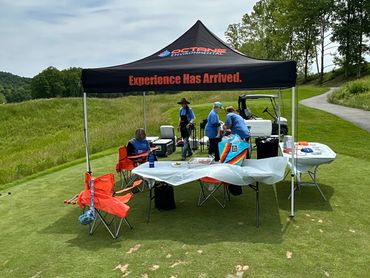 Octane EZ Up with people manning the food booth at the golf tournament