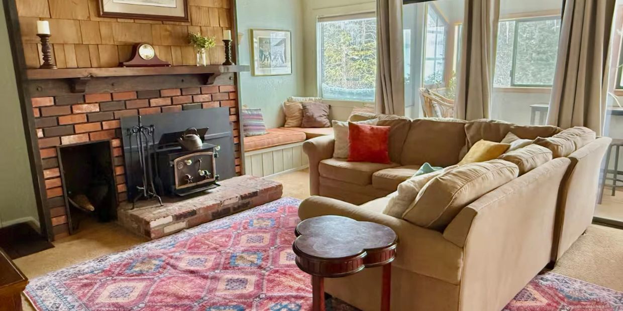 Cozy living room with a brick fireplace and sectional sofa.