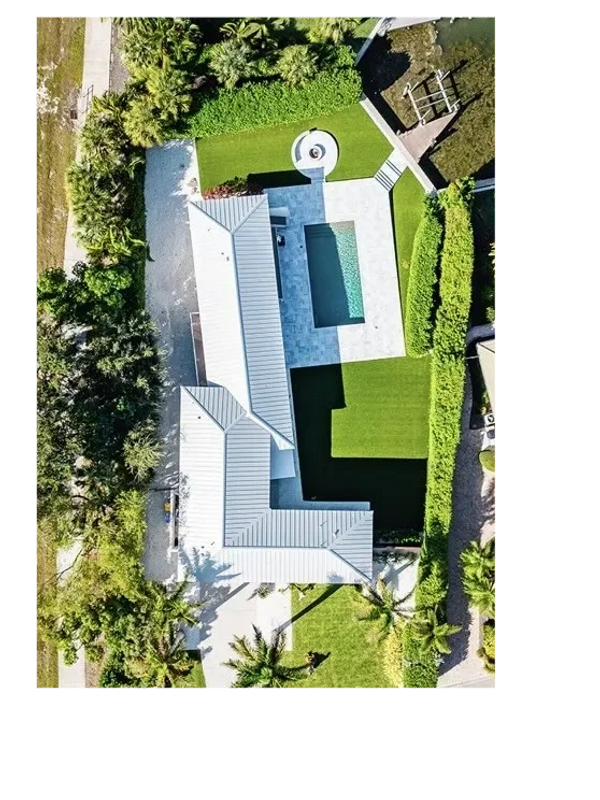 Overhead view of large white house.