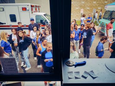 A group of people waiting for pizza at a pizza food truck in the Chicagoland area