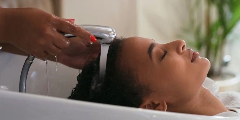 Woman relaxing as her hair is washed at a salon.