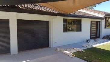Freshly painted house exterior with covered patio.