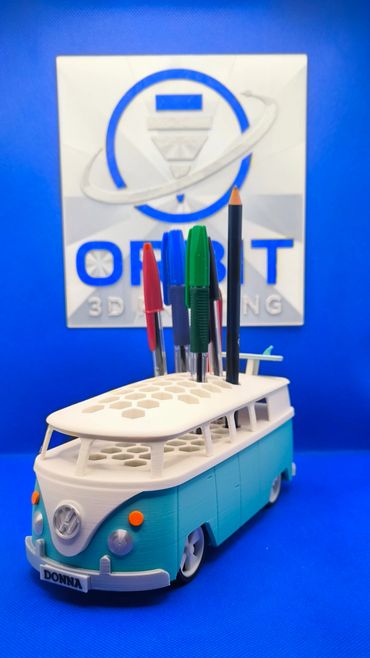 3D-printed Volkswagen bus pen holder with pens and pencil.