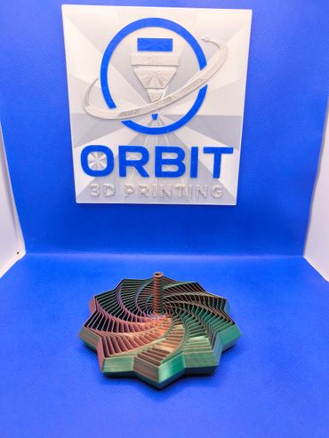 Colorful 3D printed spiral object with Orbit 3D Printing logo in background.