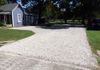 Crushed limestone topping stone over roadbase for a new gravel parking lot in Aubrey, Texas.