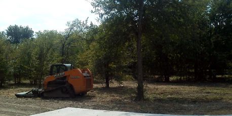 Brush Cutting and vegatation clearing using a skid steer mounted mower in Bridgeport, Texas.