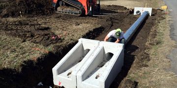 Precast concrete sloped safety ends and double culvert pipe installation in Aubrey, Texas. 