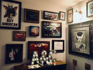 Dimly lit gallery wall with the bride of Frankenstein, Star Trek, and Batman.