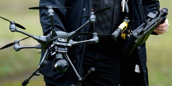 Secuvia Security Officer holding a drone patrol unit.