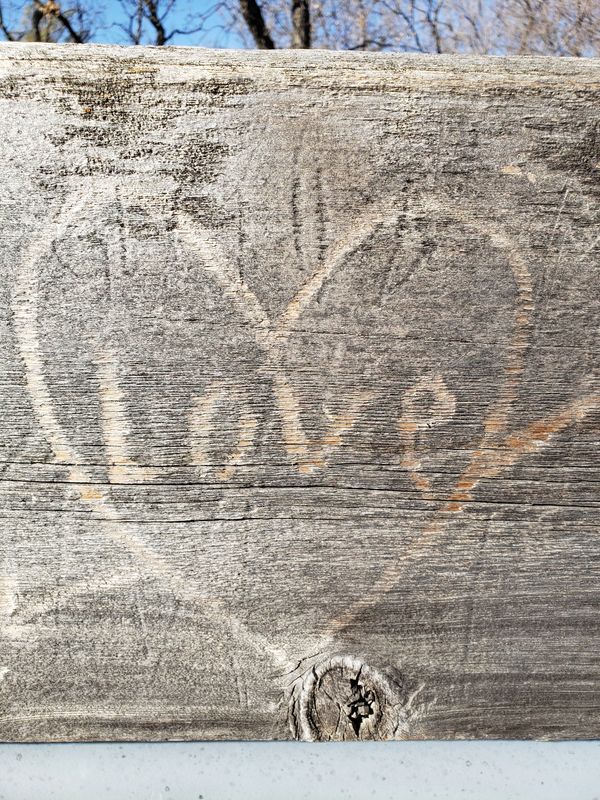 Love engraved in wood railing