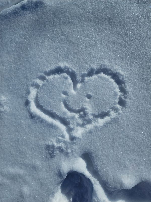 Heart shape with smiley face in snow