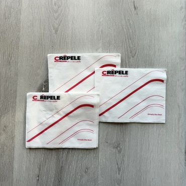 White napkins with a custom printed logo and stripe