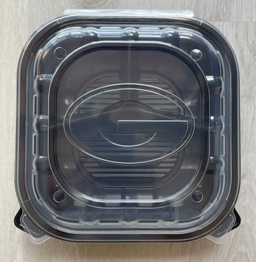 Custom embossed lid on a black takeout container