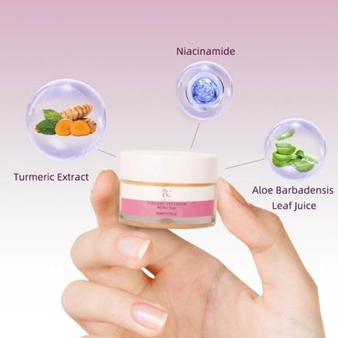 Hand holding turmeric eye cream with ingredients highlighted.
