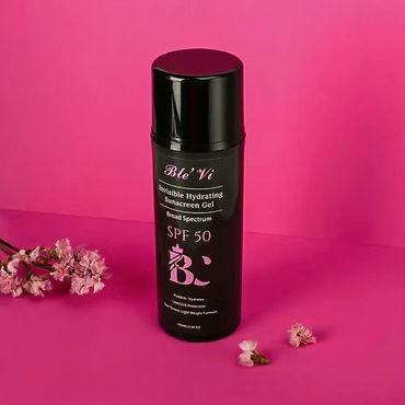 Black bottle of Blé'Vi Invisible Hydrating Sunscreen Gel SPF 50 on pink background.