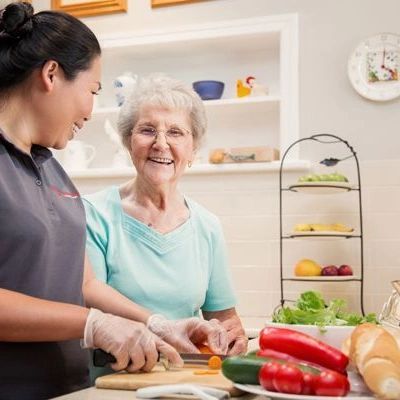 Caregiver helping a client with food preparation.
