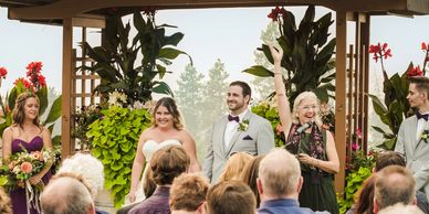 Celebrant Alison Moore cheering the guests and the wedding couple at Summerhill Winery.