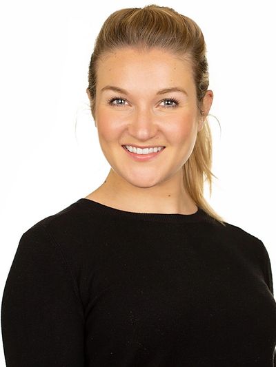 a smiling woman dressed in a black shirt